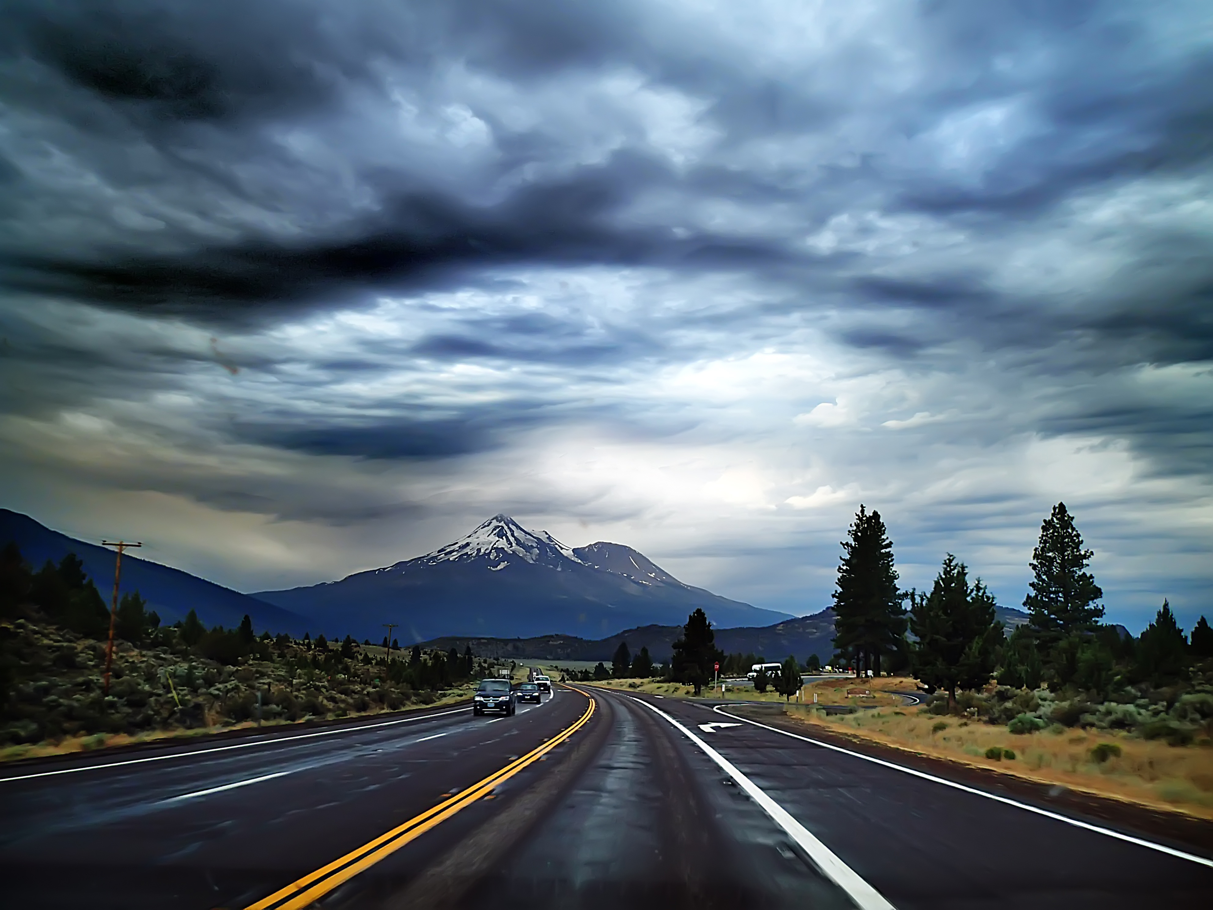 Road With Background Of Mountains And Clouds